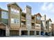 Exterior of condos showing stone accents, wood siding, and multiple balconies at 8489 Canyon Rim Cir # 302, Englewood, CO 80112