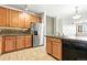 Kitchen with cabinets and stainless appliances with view of living room area at 8489 Canyon Rim Cir # 302, Englewood, CO 80112