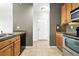 Open kitchen view with tile flooring, cabinets and stainless appliances at 8489 Canyon Rim Cir # 302, Englewood, CO 80112