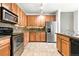 Well lit kitchen featuring stainless steel appliances and tile flooring at 8489 Canyon Rim Cir # 302, Englewood, CO 80112