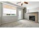 Bright living room featuring neutral carpet, a fireplace, and access to the balcony at 8489 Canyon Rim Cir # 302, Englewood, CO 80112