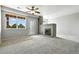 Open living room with natural light, a fireplace, and neutral carpeting at 8489 Canyon Rim Cir # 302, Englewood, CO 80112