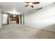 Open living room with neutral carpet adjacent to the kitchen area at 8489 Canyon Rim Cir # 302, Englewood, CO 80112