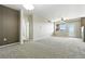 Bright living room with neutral carpet and a door to the outside at 8489 Canyon Rim Cir # 302, Englewood, CO 80112