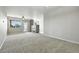 Expansive living room featuring carpeted floors, natural light, and access to a balcony at 8489 Canyon Rim Cir # 302, Englewood, CO 80112