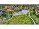 Scenic aerial view of neighborhood park with pond, bridge, walking paths, and green spaces at 5781 S Union Ter, Littleton, CO 80127
