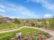 Scenic backyard view with lush landscaping, a pond, and neighborhood views in the distance under a bright sky at 5781 S Union Ter, Littleton, CO 80127