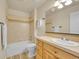 Bathroom features tile floors, tiled shower-tub combination, and a wooden vanity with a tile countertop at 5781 S Union Ter, Littleton, CO 80127