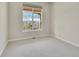Comfortable bedroom featuring a bright window offering an outside view, neutral walls and plush carpeting at 5781 S Union Ter, Littleton, CO 80127