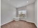 Bright bedroom with a window and seat offering natural light and views, neutral walls, and carpet flooring at 5781 S Union Ter, Littleton, CO 80127
