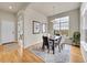 Elegant dining room with hardwood floors, a modern chandelier, and a view of the outdoors at 5781 S Union Ter, Littleton, CO 80127