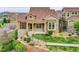 Charming home featuring a lush front yard, stone accents, and immaculate landscaping at 5781 S Union Ter, Littleton, CO 80127