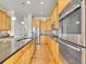 Spacious kitchen featuring stainless steel appliances, custom cabinets, granite countertops, and hardwood floors at 5781 S Union Ter, Littleton, CO 80127
