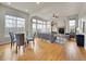 Bright living room featuring hardwood floors, a stone fireplace, and large windows for ample natural light at 5781 S Union Ter, Littleton, CO 80127