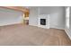Spacious living room featuring a fireplace, neutral carpet, and a wet bar with wooden cabinets at 5781 S Union Ter, Littleton, CO 80127
