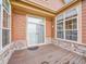 Cozy covered patio area featuring wood flooring, stone accents, and multiple windows for natural light at 5781 S Union Ter, Littleton, CO 80127