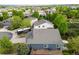 An aerial view shows a grey roof, well kept yard, and a patio set in the backyard at 16839 Trail View Cir, Parker, CO 80134