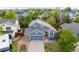 An aerial view of a two-story home with a blue exterior and a well-kept lawn at 16839 Trail View Cir, Parker, CO 80134