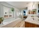 Bright bathroom with a bathtub, glass shower, and double vanity sinks at 16839 Trail View Cir, Parker, CO 80134