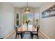 Dining room featuring modern light fixture, large window, and decorative rug at 16839 Trail View Cir, Parker, CO 80134