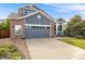 Charming two-story home featuring a two-car garage, manicured lawn and welcoming entryway at 16839 Trail View Cir, Parker, CO 80134