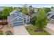 Beautifully landscaped home featuring brick accents, a bay window, and a two-car garage at 16839 Trail View Cir, Parker, CO 80134
