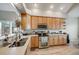 Well-lit kitchen features stainless steel appliances, light wood cabinets, and hard wood floors at 16839 Trail View Cir, Parker, CO 80134
