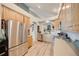 Well-lit kitchen features stainless steel appliances, light wood cabinets, and hard wood floors at 16839 Trail View Cir, Parker, CO 80134