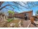 Well-maintained backyard with mature landscaping, a cozy patio area, and privacy fencing creating a serene oasis at 20137 E Prentice Pl, Centennial, CO 80015