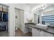 Bright bathroom with stone counters, storage, and a shower/tub combo at 20137 E Prentice Pl, Centennial, CO 80015