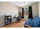 Cozy bedroom with wood floors, large windows, and a comfortable futon at 20137 E Prentice Pl, Centennial, CO 80015