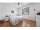 Bright primary bedroom with wood floors, ceiling fan, and large windows at 20137 E Prentice Pl, Centennial, CO 80015