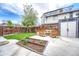 Backyard boasts a new garden bed and modern patio furniture on a concrete patio at 4720 W 39Th Ave, Denver, CO 80212