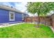Green backyard featuring a flourishing tree and a wooden fence surrounding the property at 4720 W 39Th Ave, Denver, CO 80212