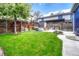Well-maintained backyard with lush green grass and patio with stylish outdoor furniture at 4720 W 39Th Ave, Denver, CO 80212