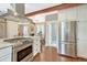 Open concept kitchen with stainless steel appliances, a gas range, and an island overlooking the living area at 4720 W 39Th Ave, Denver, CO 80212