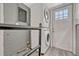Convenient laundry room with stacked washer and dryer, and a door to the exterior at 4720 W 39Th Ave, Denver, CO 80212