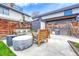 Concrete patio features modern wood furniture and a built-in patio with a wooden fence at 4720 W 39Th Ave, Denver, CO 80212