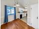 Bright dining room with hardwood floors and access to kitchen at 12780 E Bethany Pl, Aurora, CO 80014