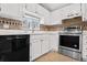 Kitchen with stainless steel appliances and white cabinets at 12780 E Bethany Pl, Aurora, CO 80014