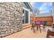 Inviting patio with stone wall, table, chairs, and grill at 12780 E Bethany Pl, Aurora, CO 80014