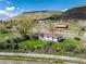 Aerial view of a charming home with surrounding landscape and barn at 4972 Easley Rd, Golden, CO 80403