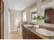 Bathroom with a double sink vanity, granite counters, and bright natural light at 4972 Easley Rd, Golden, CO 80403