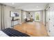 Sunlit bedroom with neutral decor, hardwood floors, stylish furnishings, and windows overlooking the neighborhood at 4972 Easley Rd, Golden, CO 80403