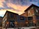 Exterior view of New Terrain Brewing Company, featuring stone and wood facade under a vibrant sunset sky at 4972 Easley Rd, Golden, CO 80403