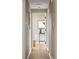 Hallway view with light walls and floors leading to another room at 4972 Easley Rd, Golden, CO 80403