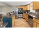 Contemporary kitchen with stainless steel appliances, a stylish blue island and sleek wood floors at 4972 Easley Rd, Golden, CO 80403