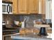 Kitchen corner showcasing granite countertops, light wood cabinets, and stainless steel microwave at 4972 Easley Rd, Golden, CO 80403