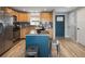 Modern kitchen featuring an island, stainless steel appliances, and natural wood cabinetry at 4972 Easley Rd, Golden, CO 80403