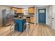 Bright kitchen equipped with an island, stainless steel appliances, and light wood cabinets at 4972 Easley Rd, Golden, CO 80403